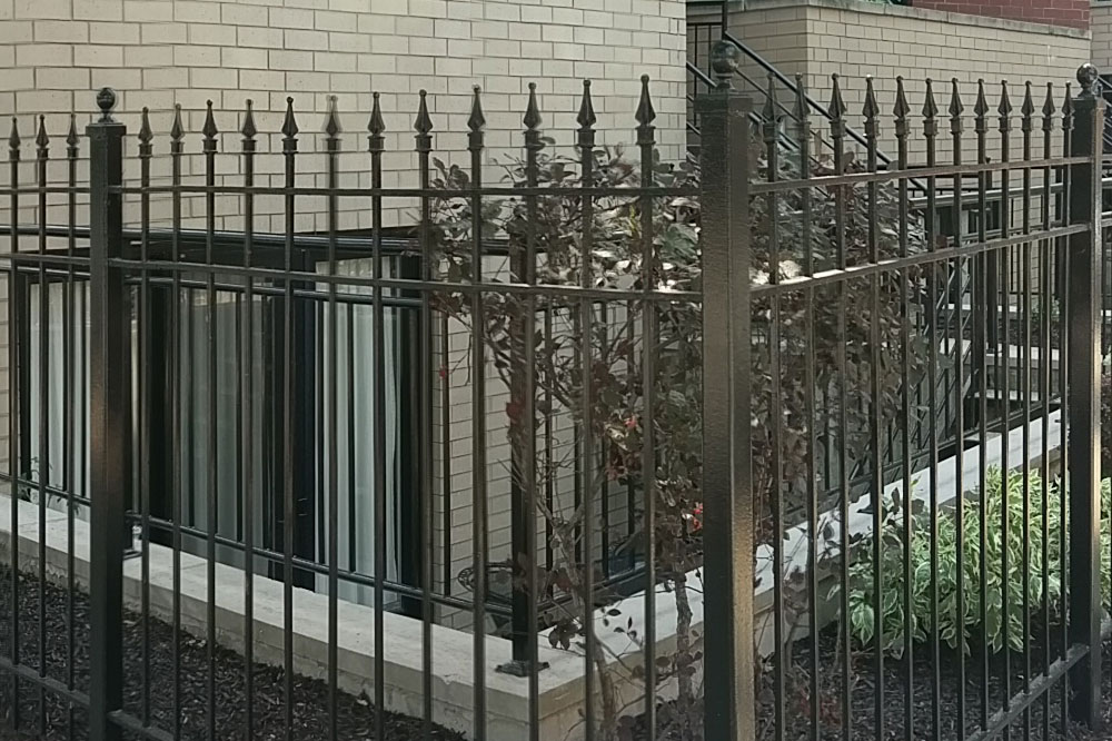 Black painted metal or wrought iron fence
